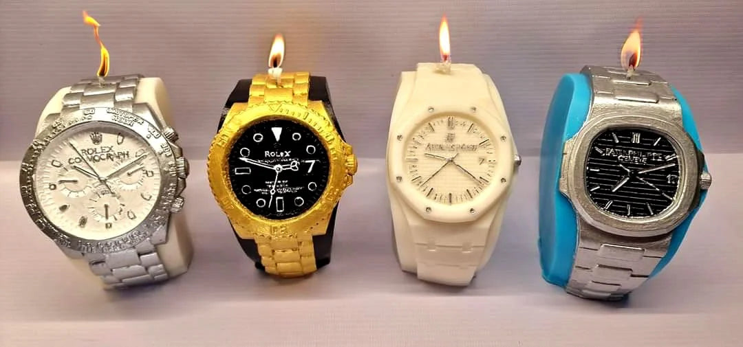 Colorful candle replicas of Rolex watches with flames, showcasing artisan craftsmanship and eco-friendly materials.