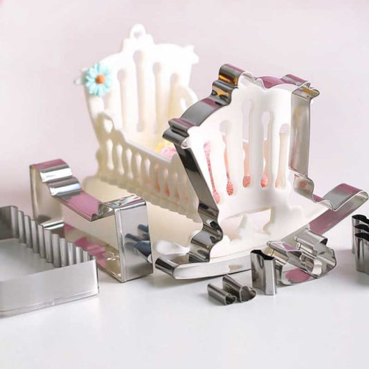 Rocking cradle. Metal cookie cutter.